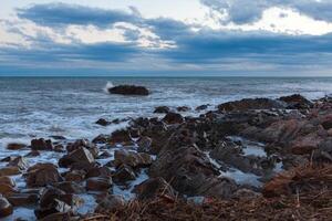 sharped stone in the sea or ocean foam wave photo