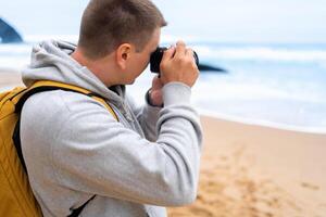 Traveler photographer takes photo beautiful seascape