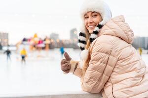 Winter woman portrait. Beautiful middle age caucasian female standing outdoor dressed funny fluffy hat looking camera smile photo