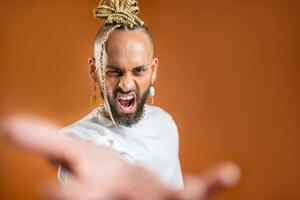 Black latin gay man outstretching empty hand towards camera photo