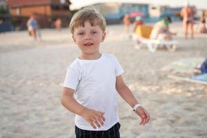 Caucasian boy standing beach. Childhood summertime. Family vacation photo