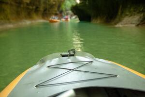 Kayaking on the river. group of people in a boat sailing along the river. Rowers with oars in a canoe. Rafting on a kayak. Leisure. photo