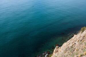 sea wave washes yellow beach of pebbles photo