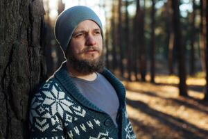 portrait of a bearded hipster tourist man in the woods forest photo