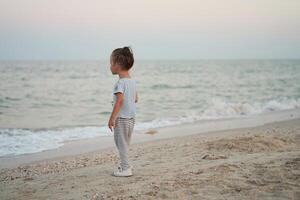 Child playing sand beach Little girl play sad alone summer family vacation photo