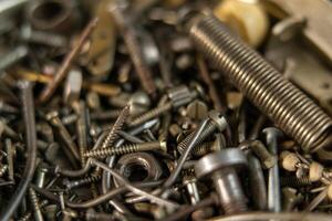 Range Rusty old screws bolts nuts. Grunge metal Hardware details photo