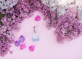 Glass jar and lilac flowers on the background for spa and aromatherapy, copy space for text. photo