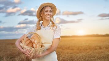 Female farmer standing wheat agricultural field Woman baker holding wicker basket bread product photo