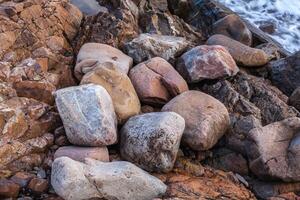 texture of sharp sea stones of different sizes photo