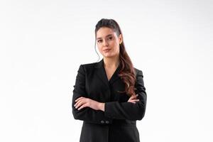 Young business woman arms crossed in black jacket standing studio isolated on white background photo