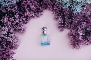 Glass jar and lilac flowers on the background for spa and aromatherapy, copy space for text. photo