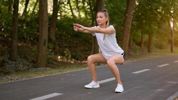 Woman runner stretching legs before exercising summer park  morning photo