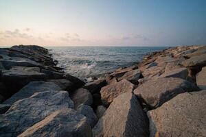 Rock breakwater in the sea in the morning photo