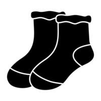 A solid design icon of socks vector