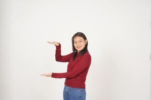 Young Asian woman in Red t-shirt Measuring and Holding Big Product isolated on white background photo