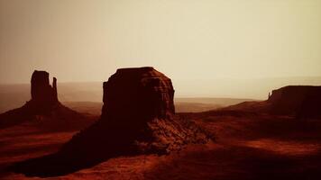 aerial view of a massive rock formation standing proudly in the desert video