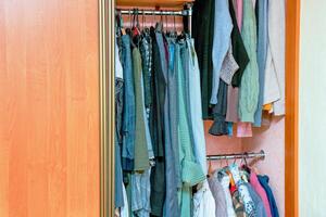 wardrobe with open door filled with clothes photo