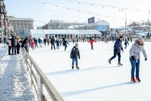 Ukraine, Kharkov 30 December 2018 People skate in the city park on Freedom Square. Excellent family leisure on weekends and holidays. photo