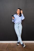 Woman use smartphone Full length photo