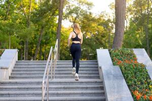 Sport and Fitness. Fit Woman Running up the steps Summer Sunny Morning Caucasian Athletic Female Jogging Outdoor Cardio Training Active Healthy Lifestyle photo