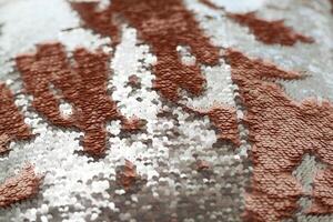Sequins close-up macro. Abstract background with gold sequins color on the fabric. photo
