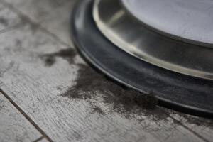 Short black male hair lies on the floor near barbershop armchair of the hairdresser after a haircut. photo