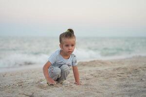 Child playing sand beach Little girl play sad alone summer family vacation photo