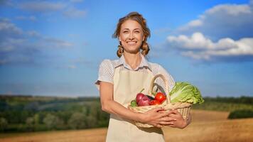 Woman farmer apron standing farmland smiling Female agronomist specialist farming agribusiness Happy positive caucasian worker agricultural field photo