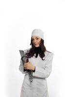 a woman in a white coat holding equipment photo