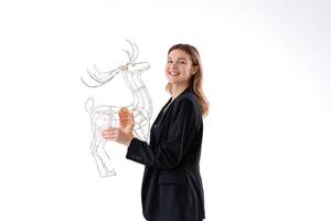 Young business woman holding illuminated Christmas deer decor dressed black suit isolated on white background photo