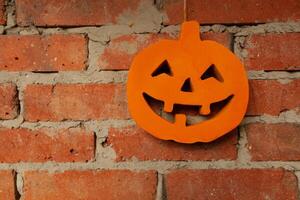 Halloween pumpkin close up on the brick wall background photo