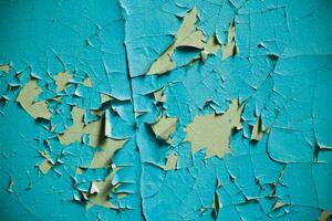 Cracked wall with old layers of paint in abandoned house photo