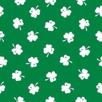 Seamless pattern with a small white clover on a green background. Happy St. Patrick's Day. Suitable for textile, wrapper, cover, brochure, wallpaper, website or banner. Vector illustration.