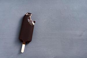 ice cream stick  on dark  background  covered chocolate sticks frozen Popsicle and Lolly sweet dessert  Flat lay photo