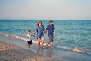 Mother father kid spending time together family vacation Parent dad mom walking with son enjoying sea beach photo