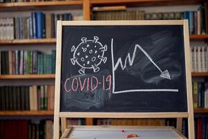 Outbreak Warning. written white chalk on blackboard in connection with epidemic of coronavirus worldwide. photo