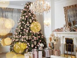 Christmas tree standing living room interior near fireplace gift box lie on carpet near evergreen fir photo