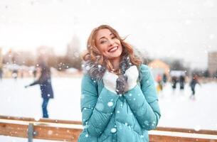 Beautiful lovely middle-aged girl with curly hair warm winter jackets stands ice rink background Town Square. photo