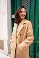 Friendly smiling attractive woman leaving building photo