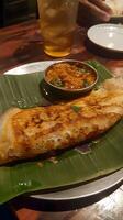 AI generated Masala dosa on banana leaf photo