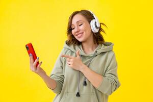 Happy teeth smile woman listen music headphones yellow background photo