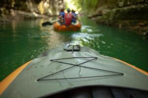 Kayaking on the river. group of people in a boat sailing along the river. Rowers with oars in a canoe. Rafting on a kayak. Leisure. photo