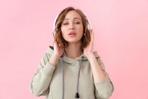 Woman listen music headphones  pink background studio shoot photo