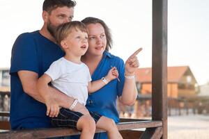 Mother father kid spending time together family vacation Parent dad mom walking with son enjoying sea beach photo