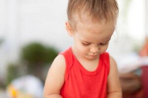 Portrait of blonde girl with blue eyes in the park. Child, baby girl close up smile photo