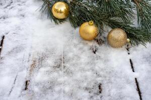 Winter background. Empty wooden plank with snowy border with pine branch and christmas ball decoration photo
