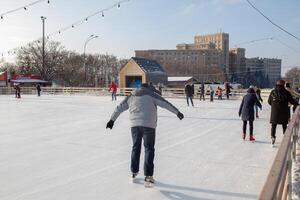 Ukraine, Kharkov 30 December 2018 People skate in the city park on Freedom Square. Excellent family leisure on weekends and holidays. photo