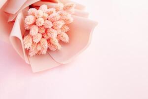 Beautiful bouquet of dry pink flowers on a wooden white background. Minimalism, space for text. Gift Card photo