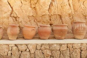 many large clay pots standing in a row photo