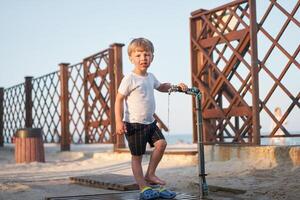 Caucasian boy standing beach. Childhood summertime. Family vacation photo